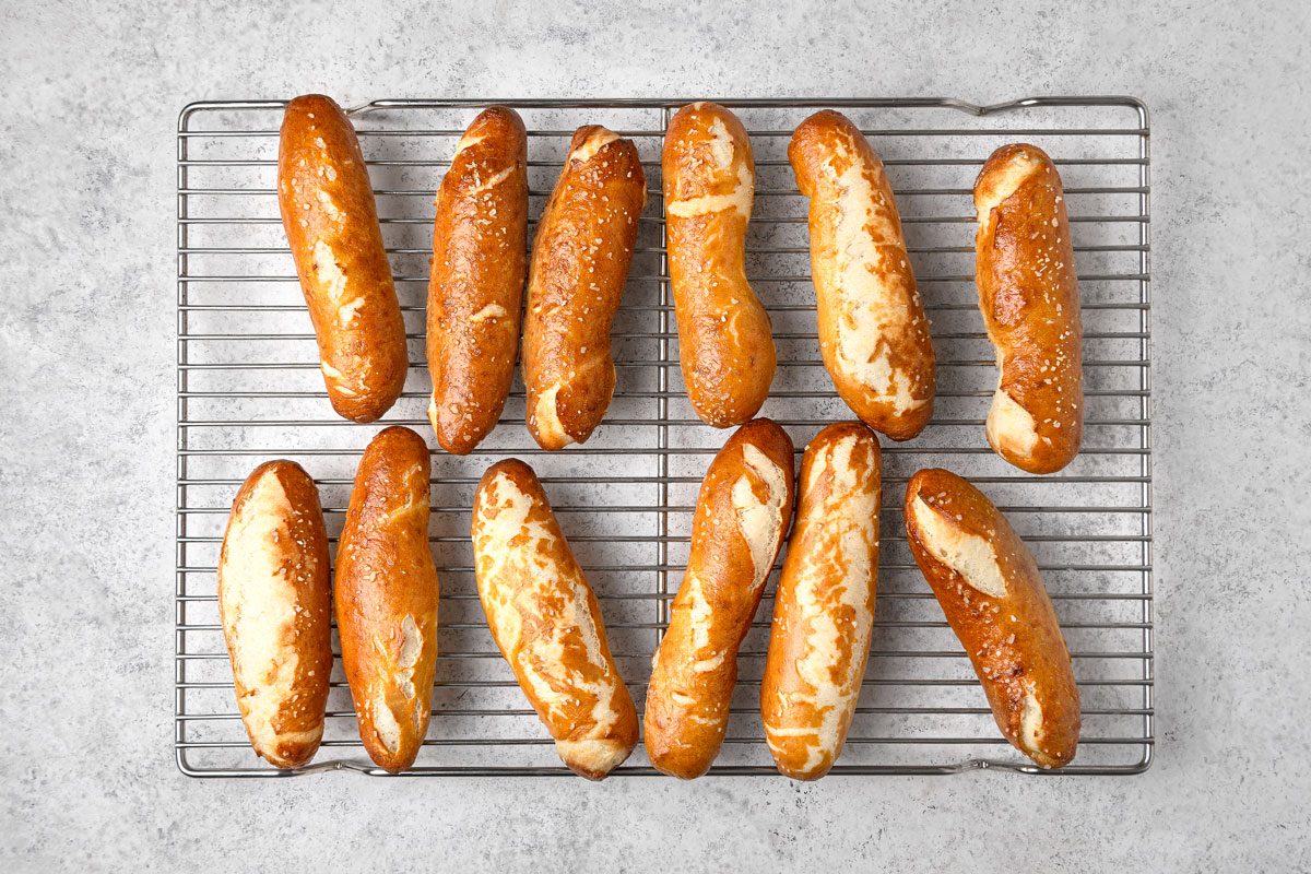 overhead shot of twelve Pretzel sticks arranged on a silver wire rack, the background is a light gray countertop or surface
