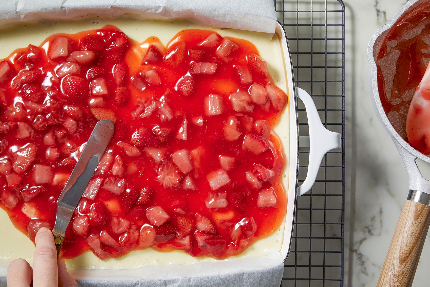 Spread the topping over the filling for Strawberry Cheesecake Bars