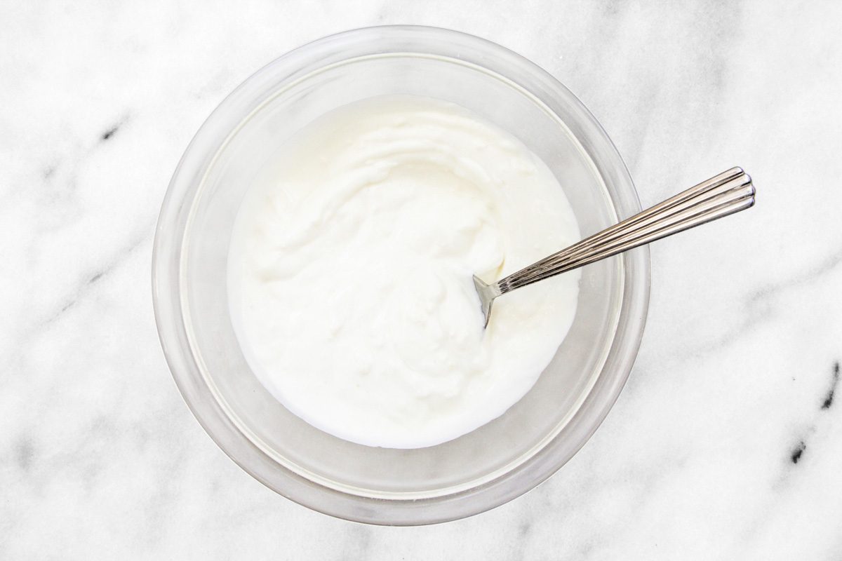 Overhead shot of minced garlic mixed with yogurt