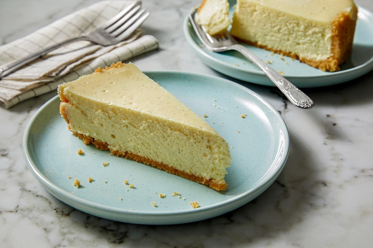 A slice of vanilla bean cheesecake placed on a plate.