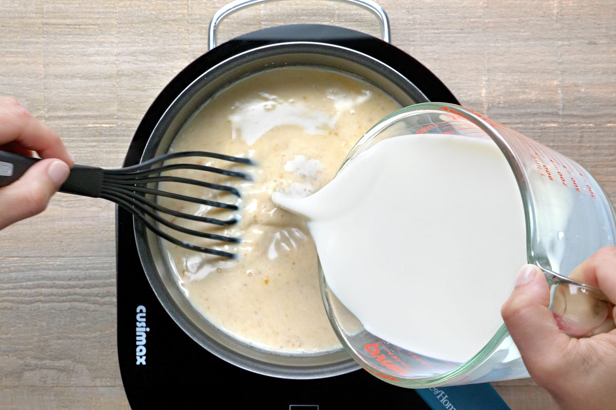milk being added to cheese sauce mixture