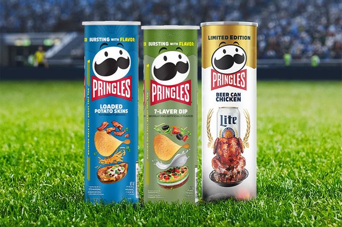 Three pringles cans: a blue "loaded potato salad" flavor, a green "7-layer dip" flavor, and a white "beer can chicken" flavor set on a football stadium background