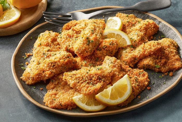 Baked Bluegill with lemon wedges on a plate