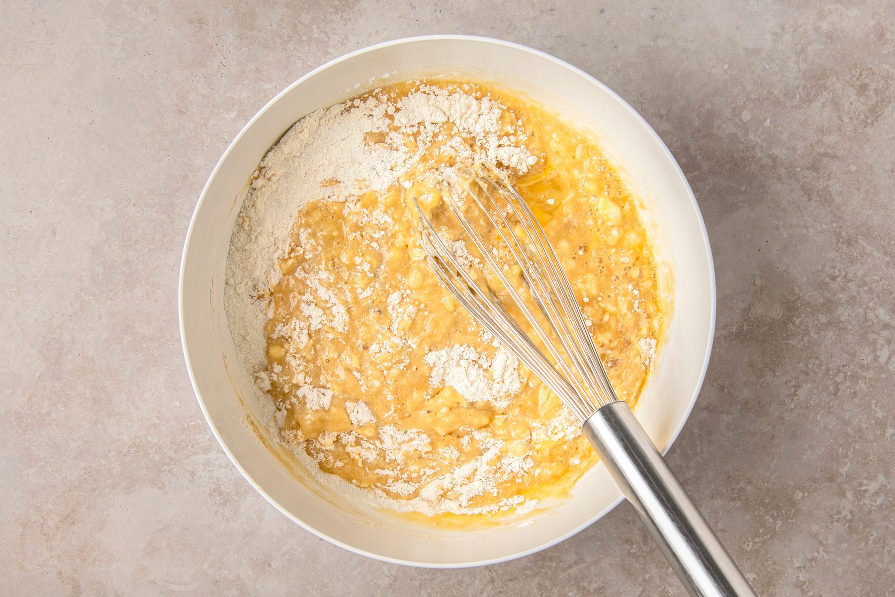 In a large bowl whisk flour; baking powder; baking soda; salt; bananas; eggs; butter; sugar; maple syrup; milk and vanilla
