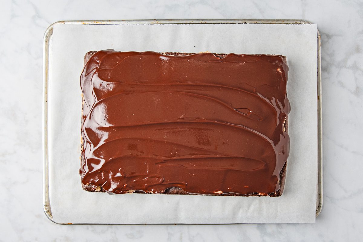 brownies with chocolate and peanut butter layers cooling in a pan