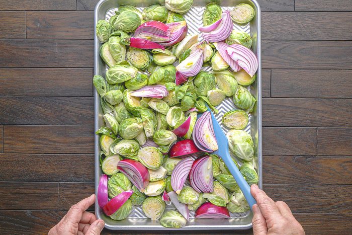 Brussels sprouts, onions, olive oil, salt and pepper tossed into a baking pan