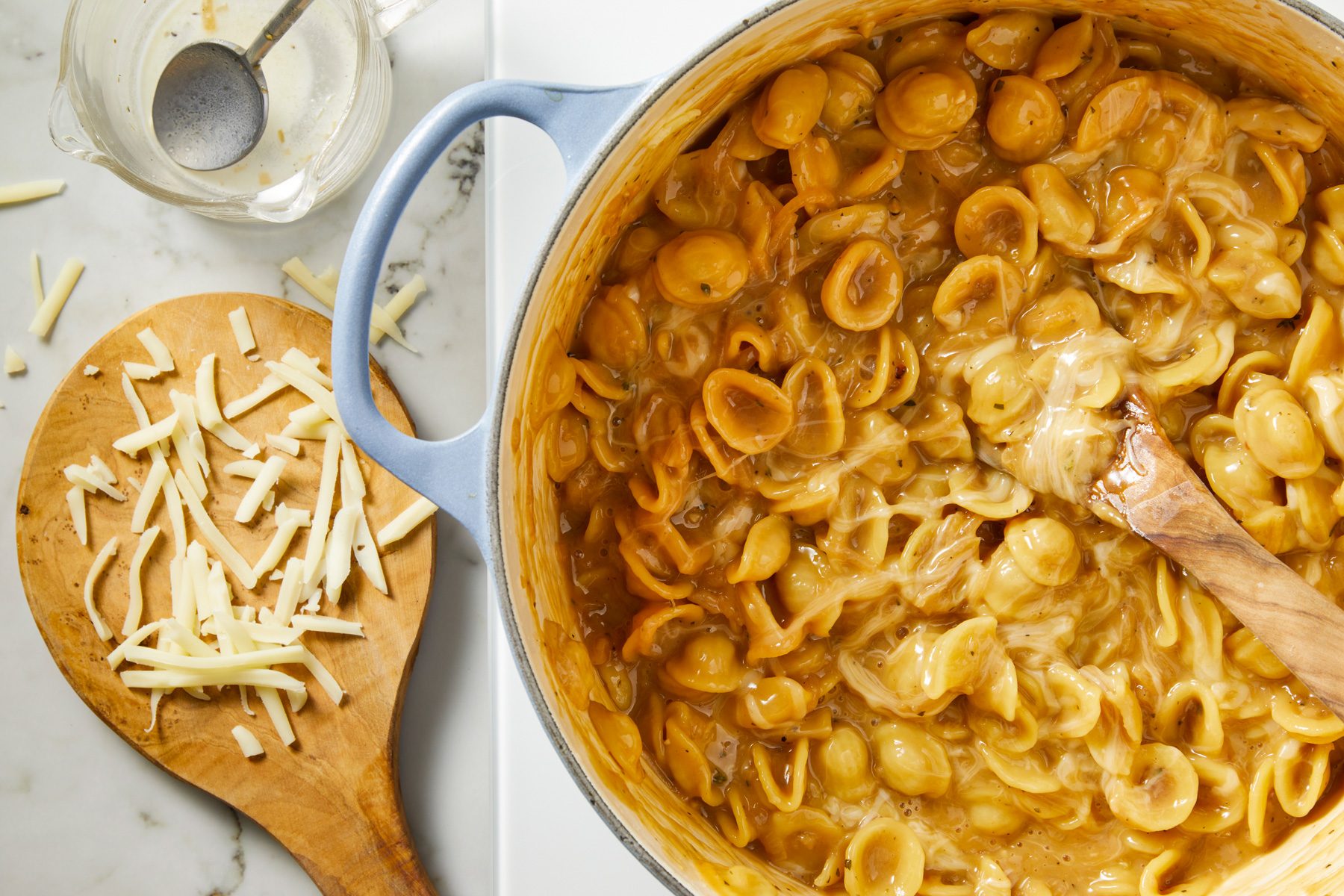Sherry vinegar stirred into the pasta, followed by a tempered cream mixture of warmed half-and-half and pasta liquid. The pasta is simmered for another 30 seconds, then removed from heat, with a saucy, not liquidy texture.