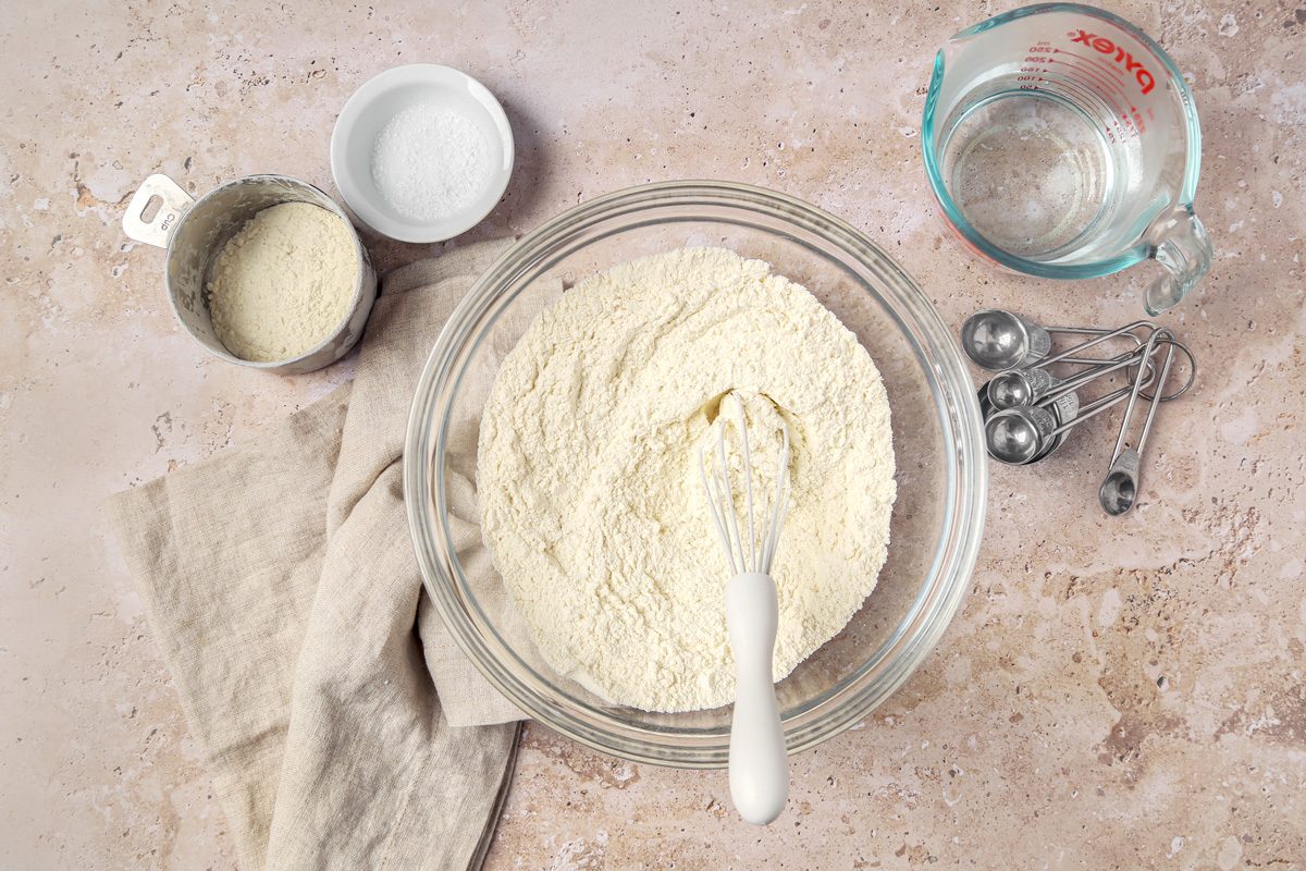A small bowl containing a mixture of flour, baking powder, and salt