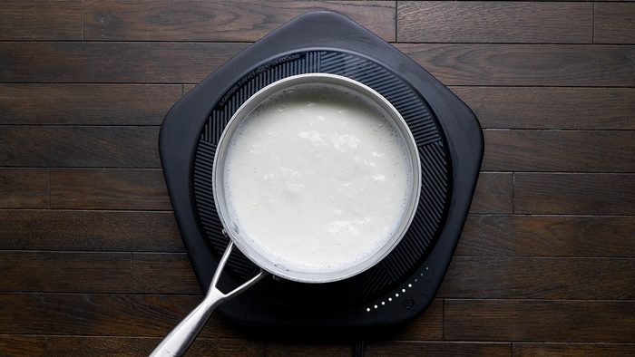 In a large saucepan or pot bring whole milk and water to a boil