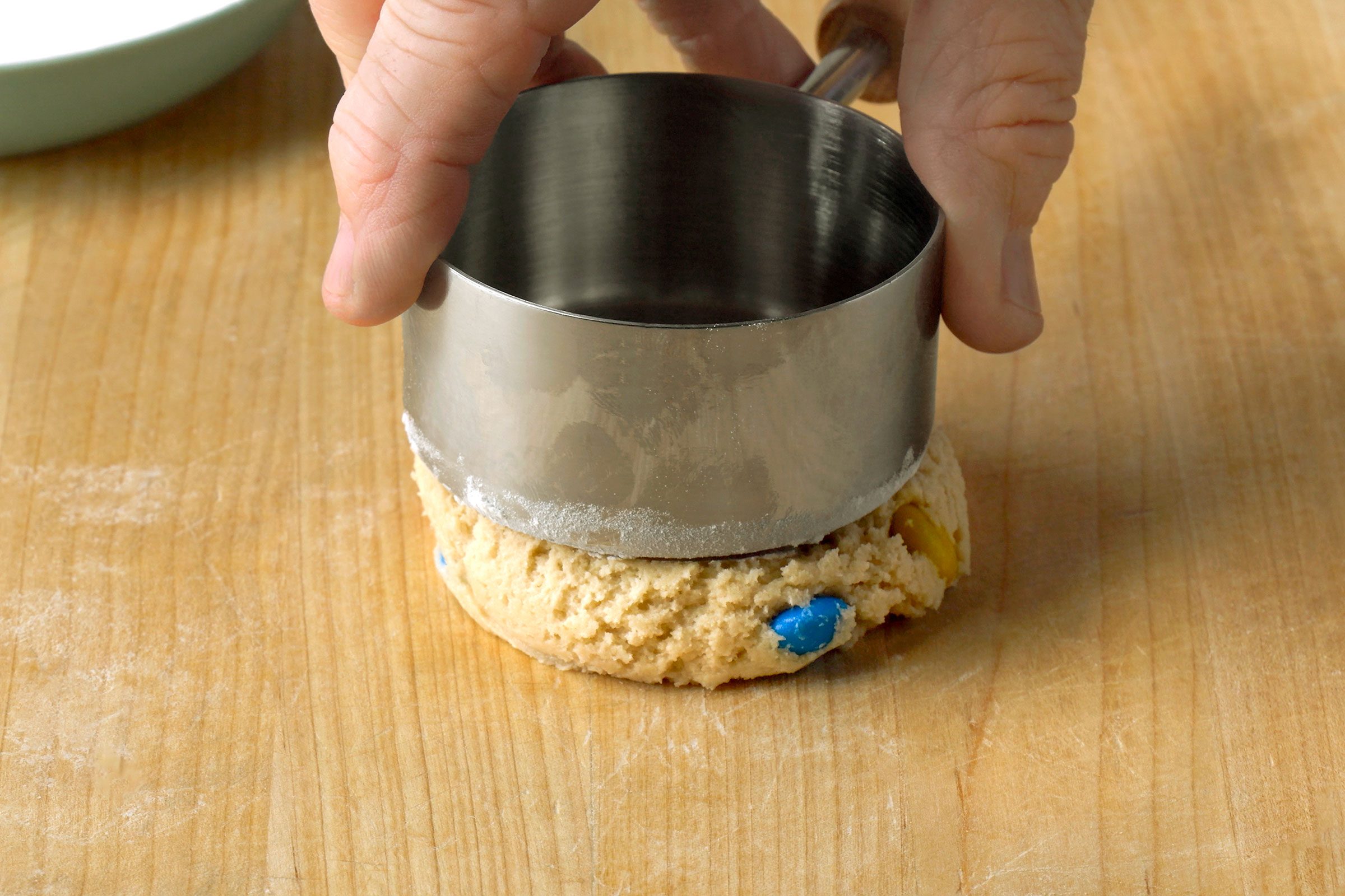 Flattening each ball to a 3/4-inch thickness