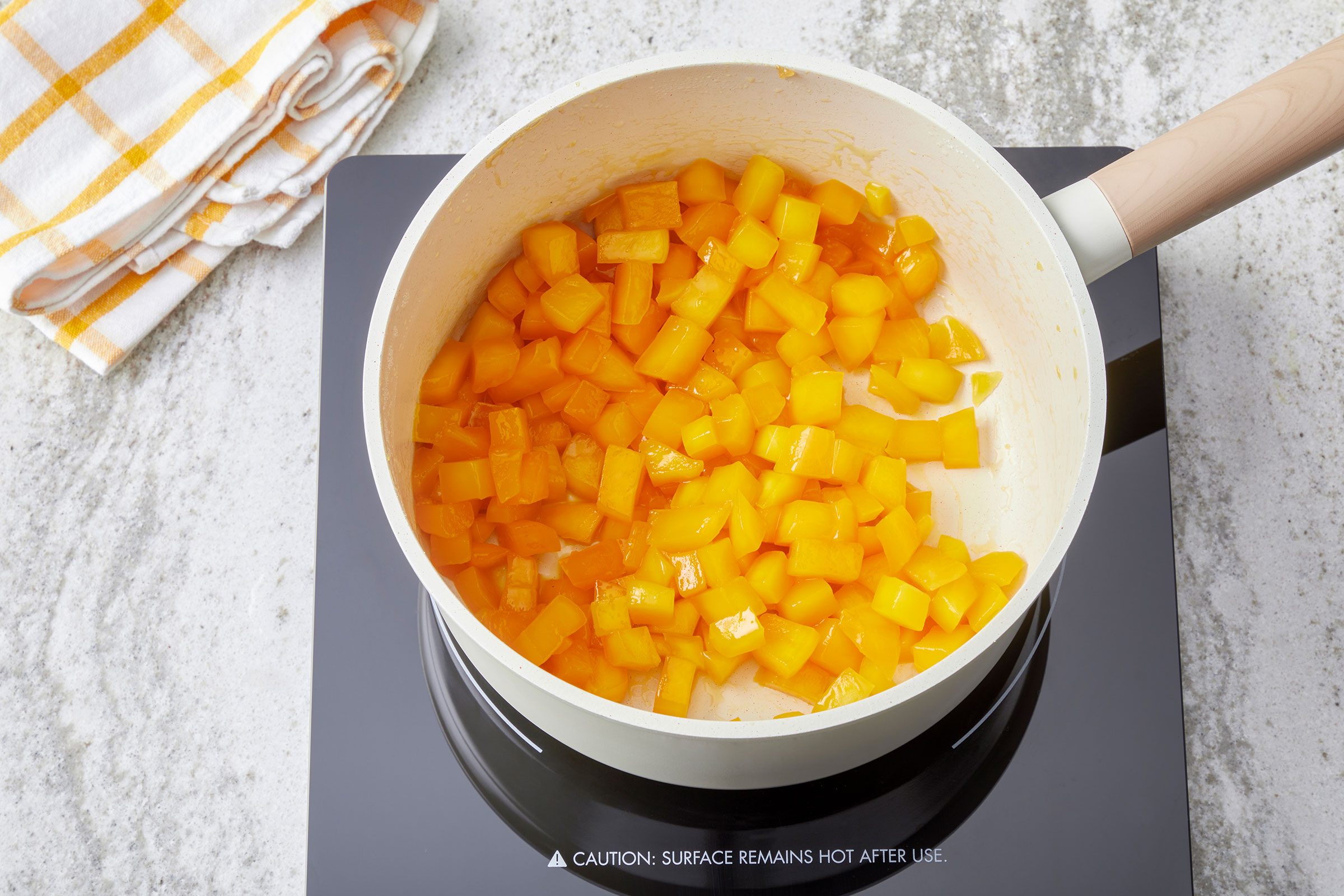 Diced mango, sugar and lemon juice cooked in a large saucepan