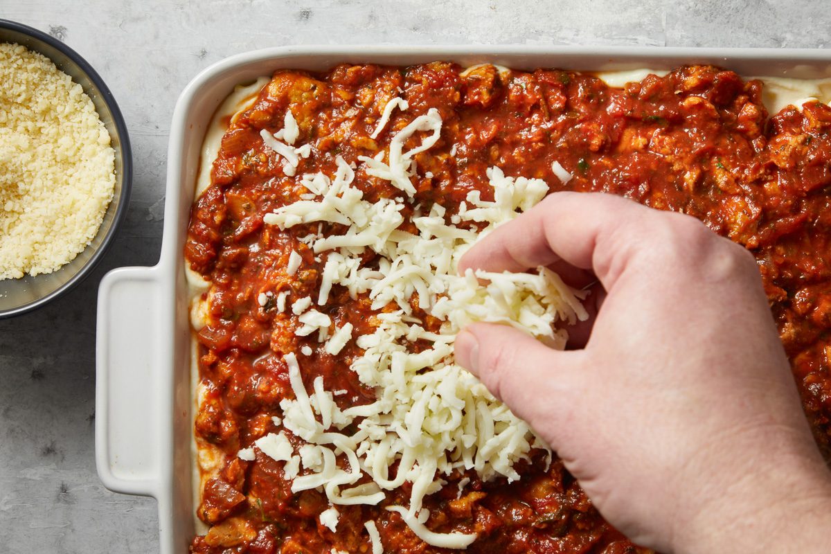 shredded mozzarella added to meat sauce