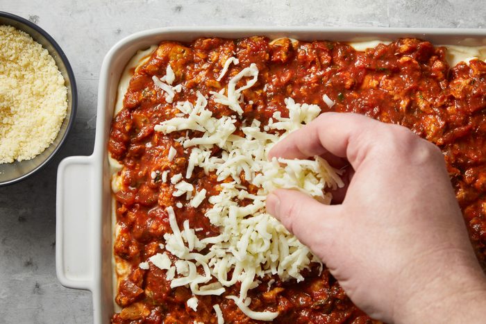 shredded mozzarella added to meat sauce