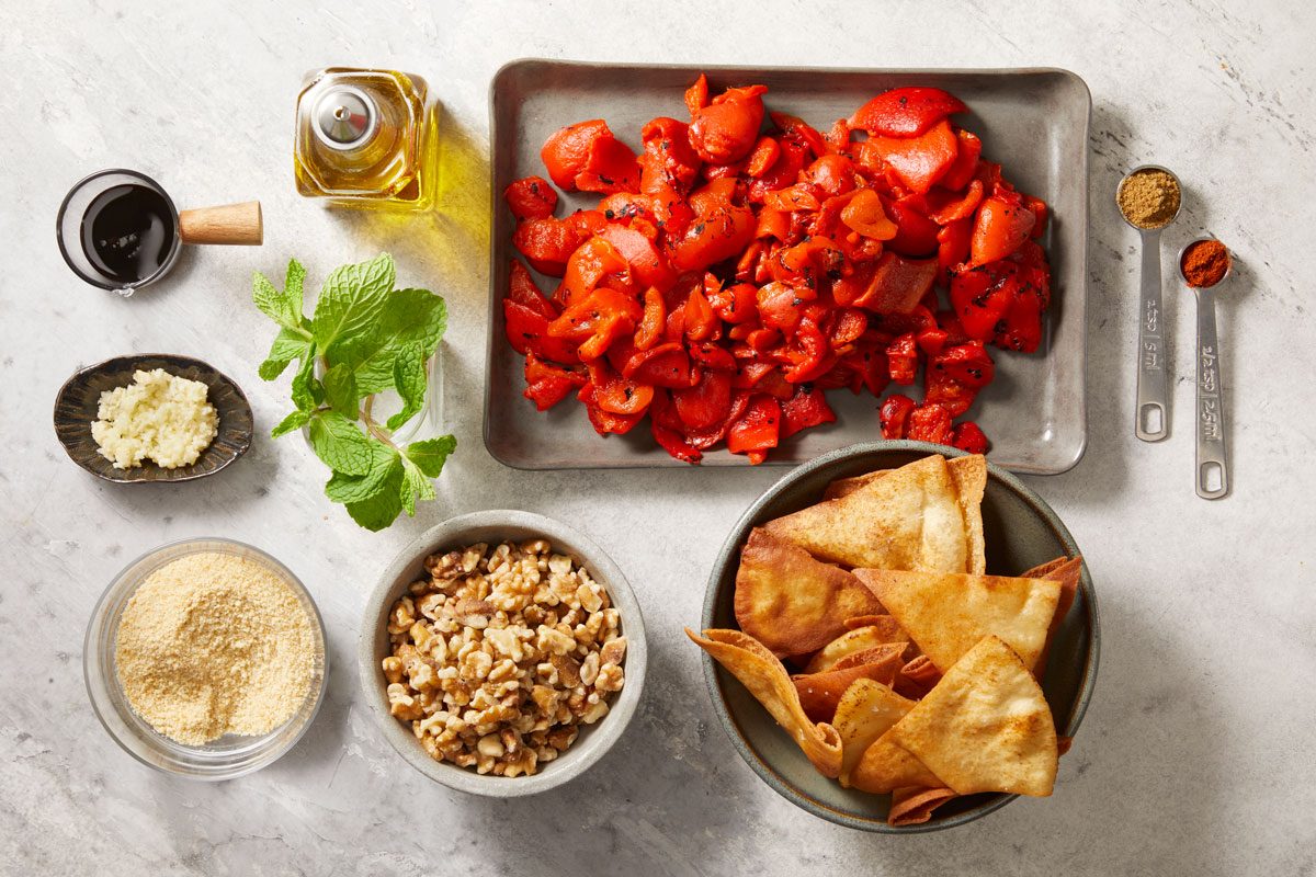 roasted red peppers, garlic, bread crumbs, walnuts, olive oil, cumin, pita chips and herbs