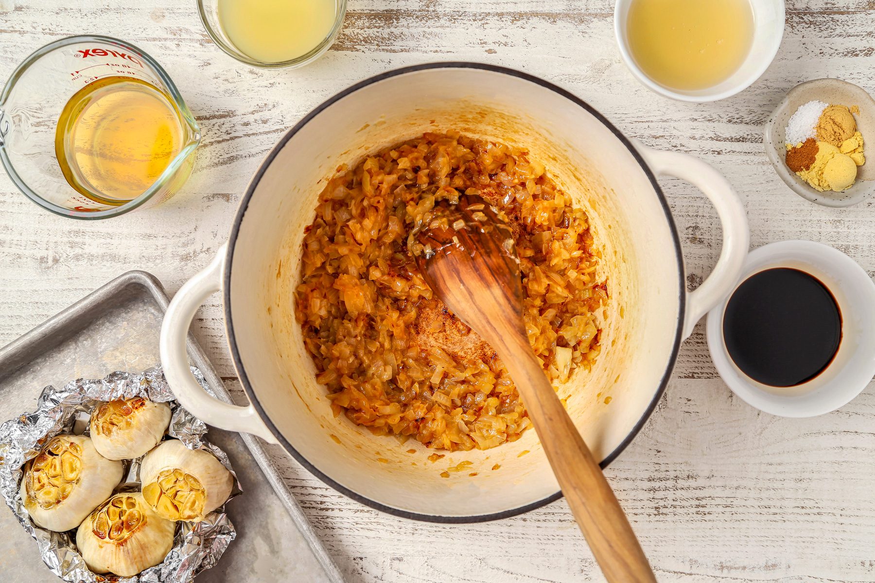 Chopped onions cooking in butter in a dutch oven