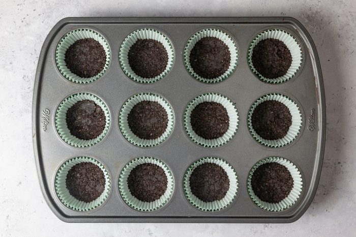 Oreo crusts set in a tray, ready to bake