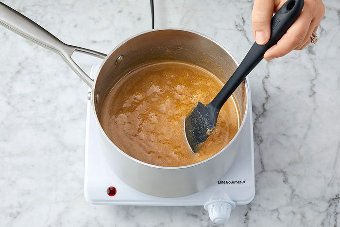 Sugar, milk, corn syrup and salt are mixed and heated in a pan