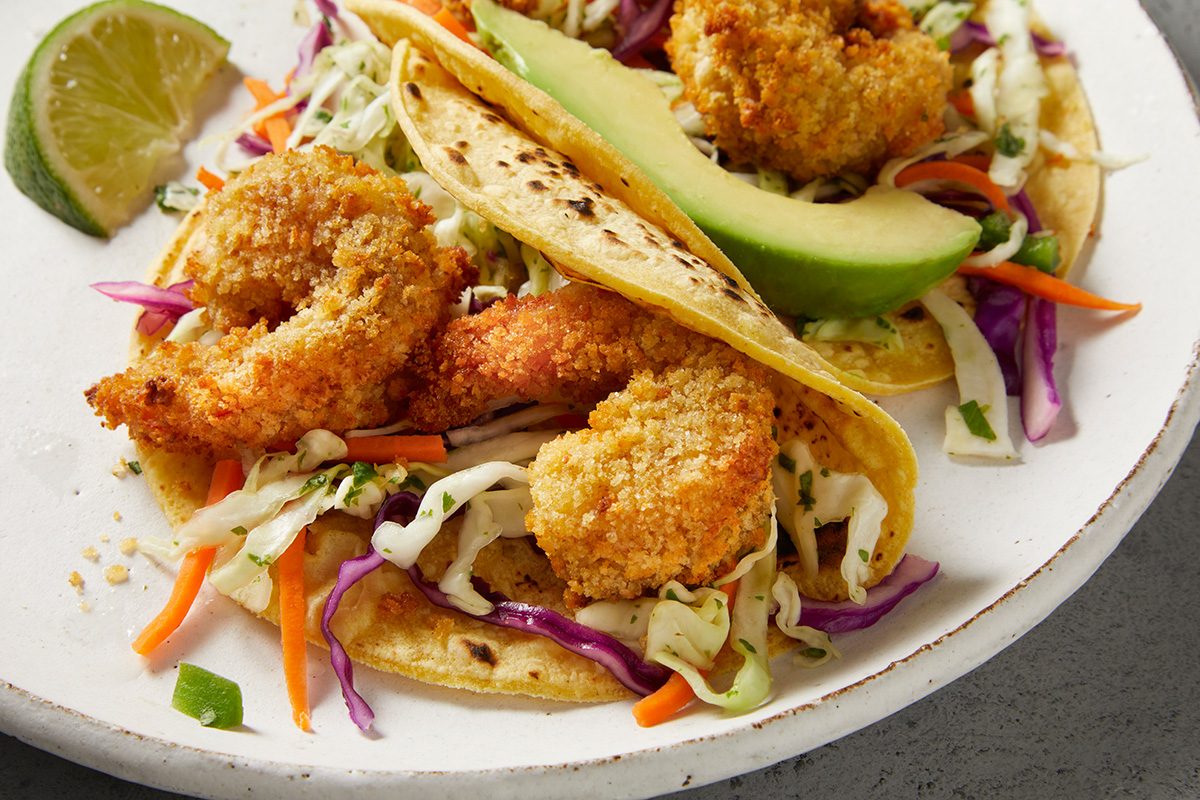 close up shot of Popcorn Shrimp Tacos with Cabbage Slaw