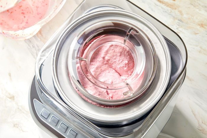 Pouring the ice cream base into the cylinder of the ice cream maker.