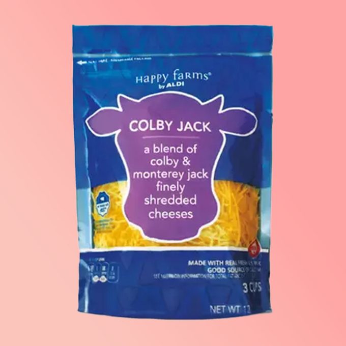 Aldi brand colby jack shredded cheese on a pink background