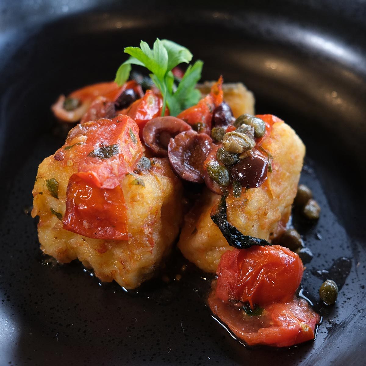 Fried cod with Livornese sauce on top