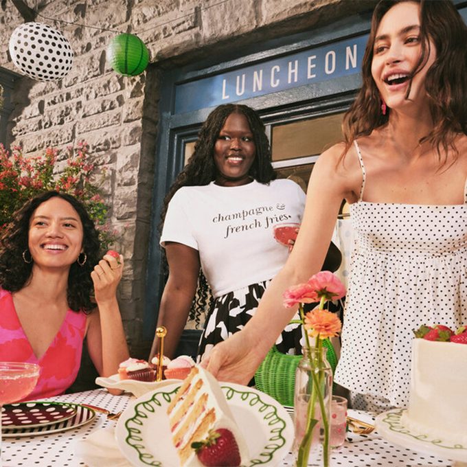 Three women enjoying an outdoor meal with Kate Spade branded items