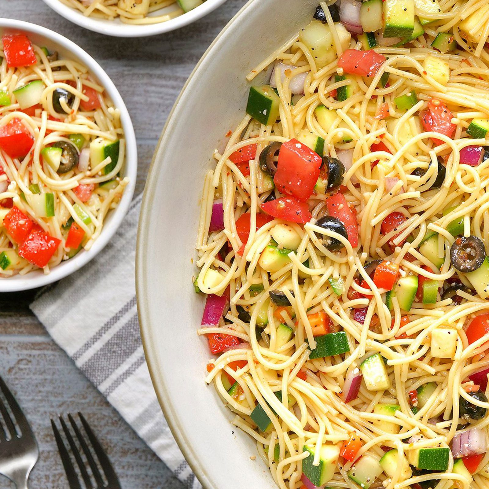 California Spaghetti Salad in a serving plate and bowls