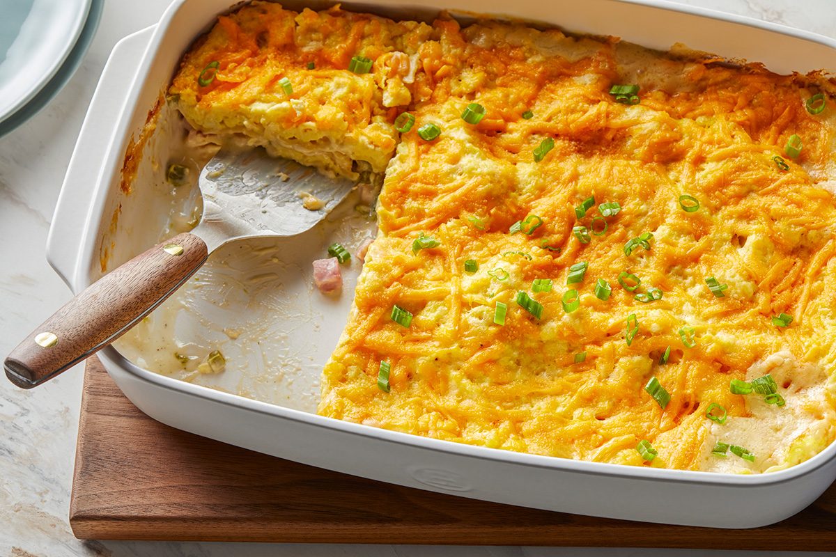 Top view shot of Brunch Lasagna; in a baking pan; top with sliced green onions