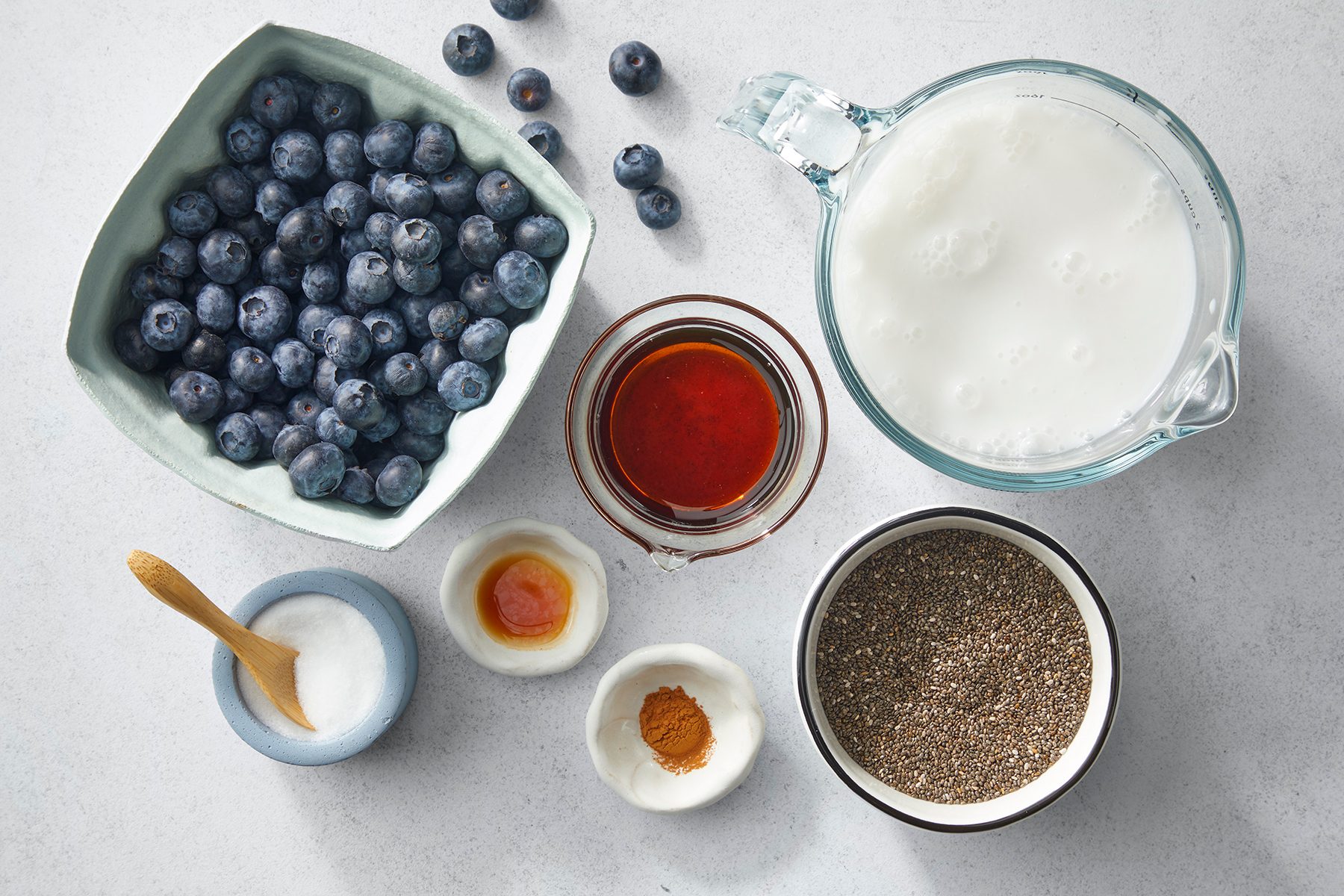 A top view of various ingredients on a light surface.