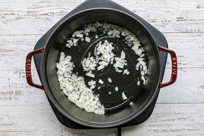 onions being sauteed in a dutch oven