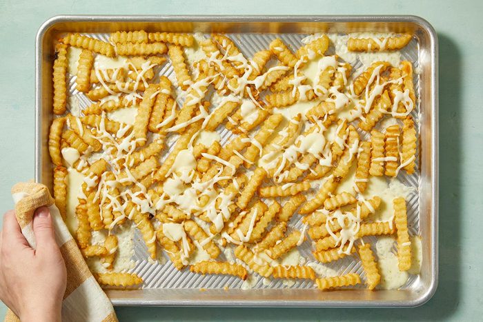 fries with shredded and cubed cheese.