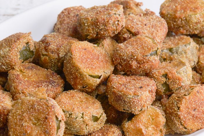 Close-up shot of Fried Dill Pickles; served on large platter