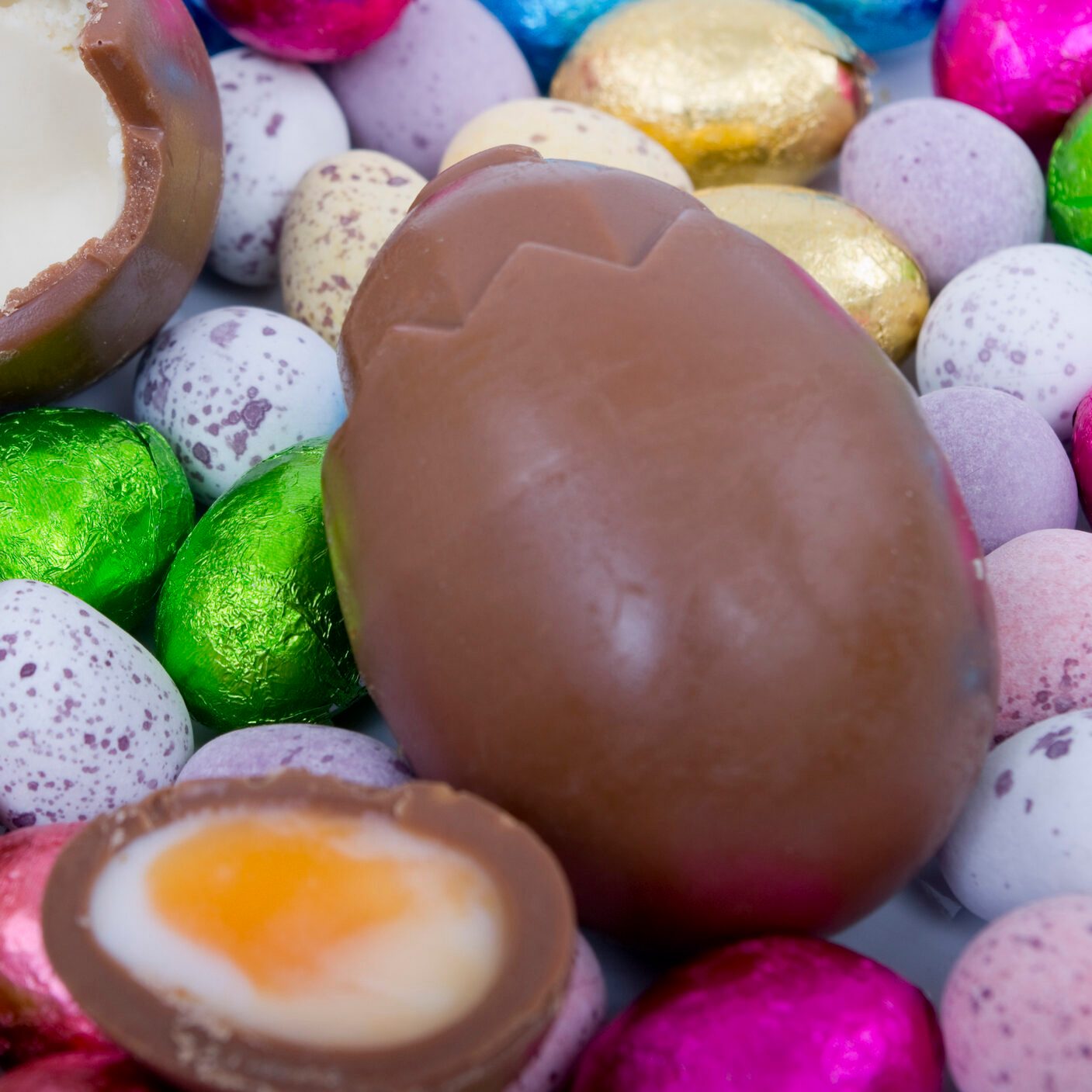 Cadbury Creme Egg above smaller chocolate eggs