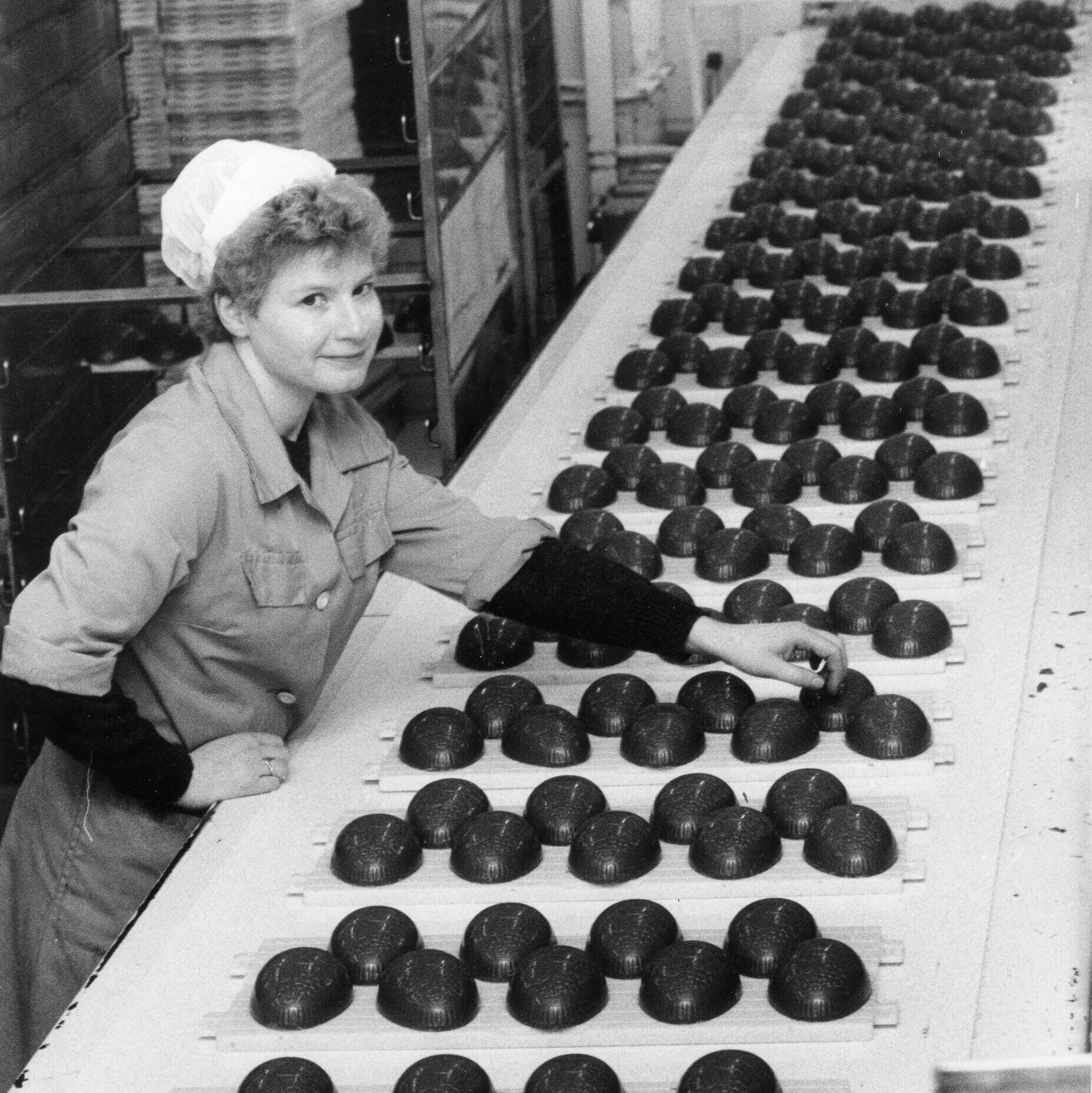 Worker next to an easter egg production line at Cadbury factory