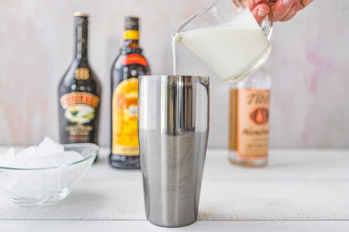 cocktail being made with Irish cream, Kahlua and heavy cream