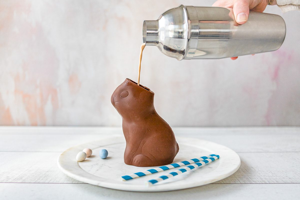 easter cocktail drink being poured into chocolate bunny