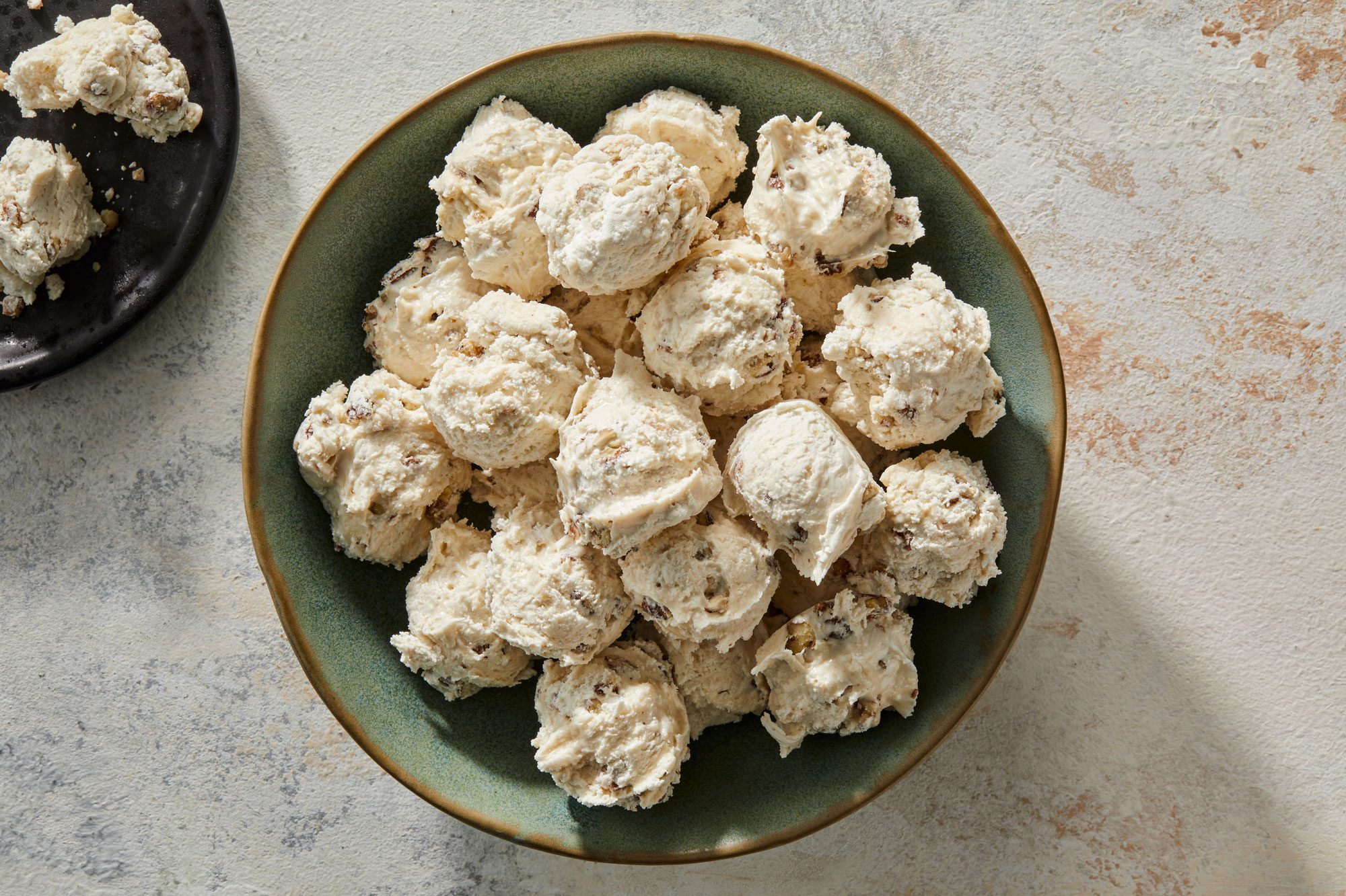 Top view shot of Microwave Divinity; in a large ceramic bowl; served on a small black plate; marble surface;