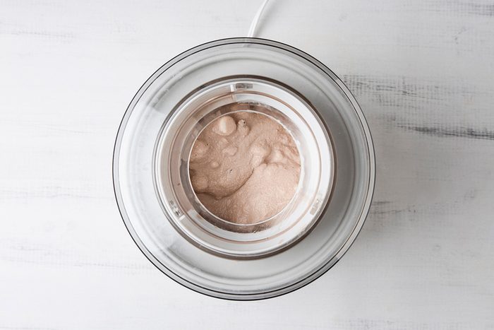 Overhead shot of fill cylinder of ice cream maker two-thirds full; freeze according to the manufacturer’s directions