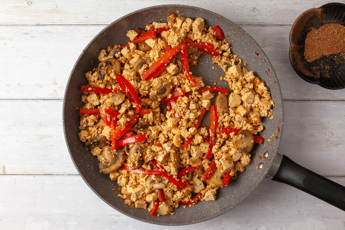 tofu added to the pan with sautéed vegetables, garlic and one tablespoonful of spice blend