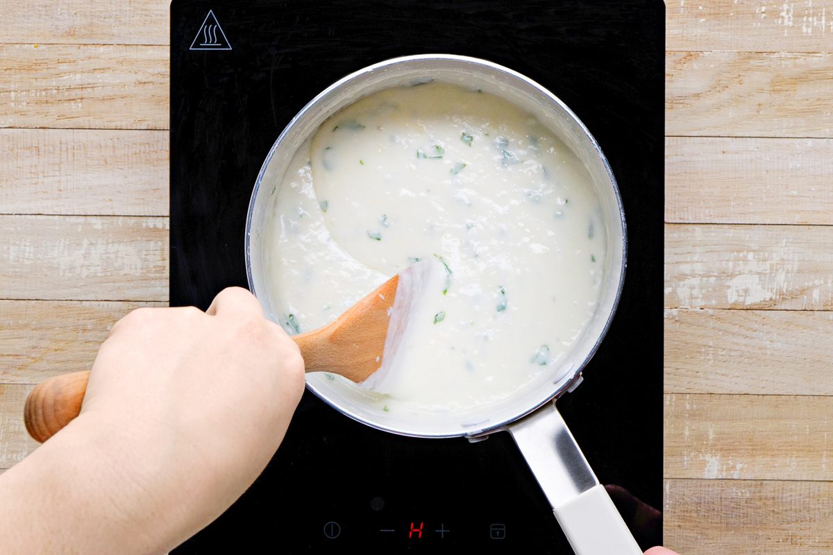 Parmesan cheese, basil, onion salt and garlic powder added to flour, butter and milk mixture