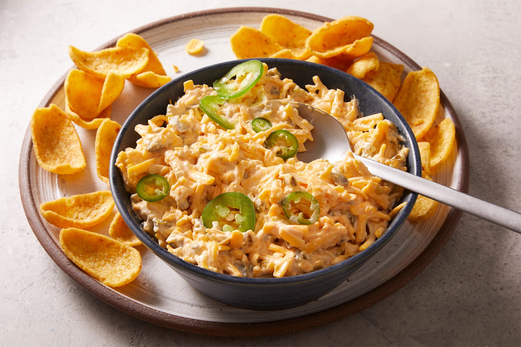 Kenai Dip in a bowl with chips on the pllate