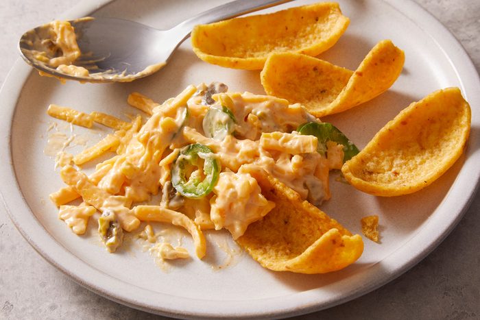 Half eaten Kenai Dip with chips on a plate