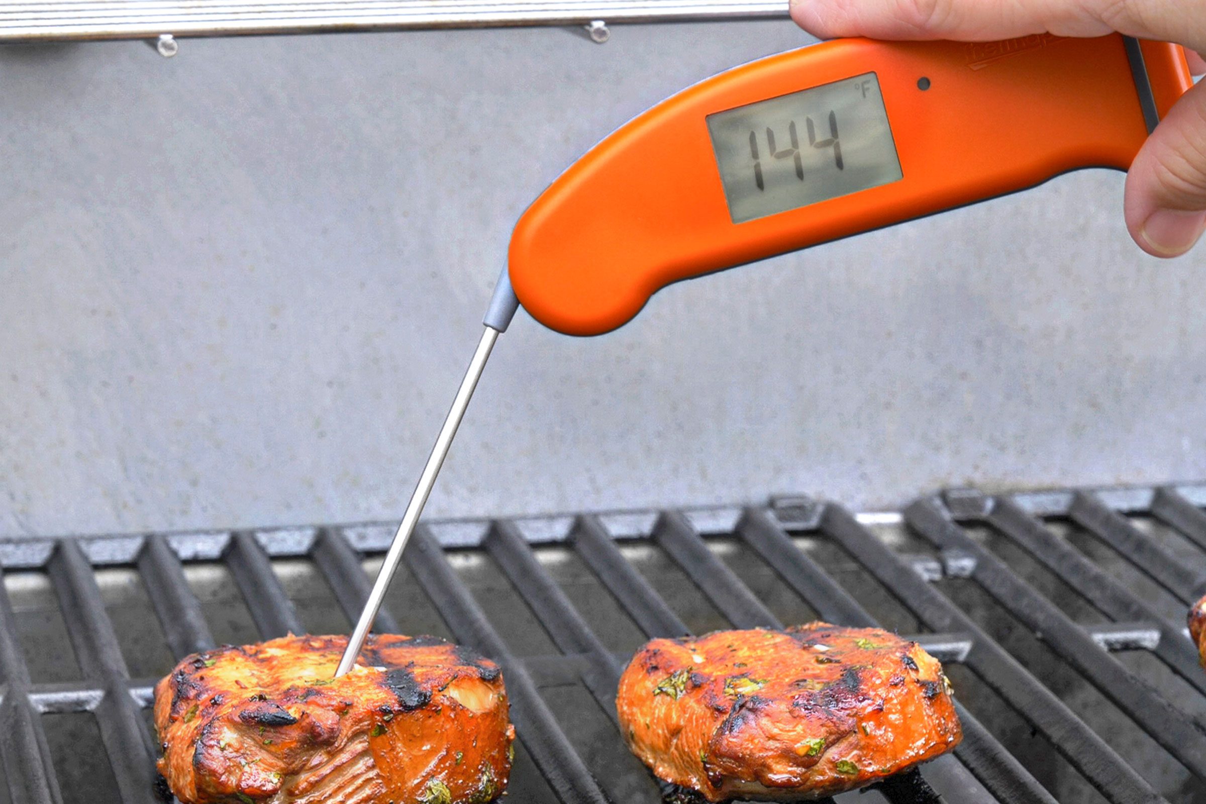 Grilling the pork chops over medium heat for 10 to 15 minutes on each side or until a thermometer reads 145°F.