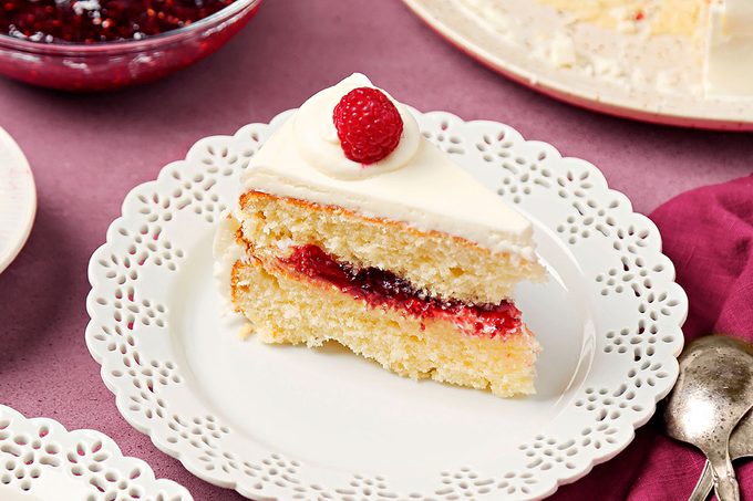 White chocolate rasberry cake slice ready to serve