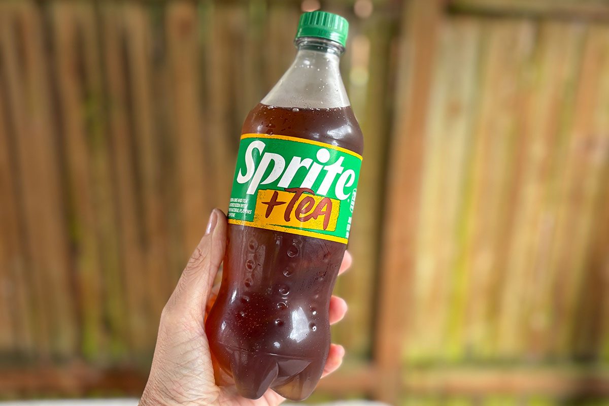 hand holding a sprite + tea beverage bottle