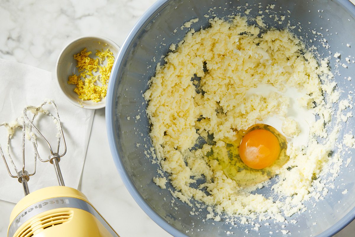 A mixing bowl with an egg and flour, indicating the start of a recipe.