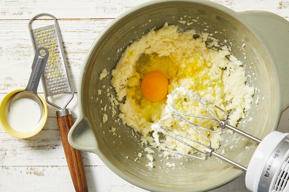 In a large bowl, cream butter and sugar until light and fluffy. Beat in the egg, cream and zest.