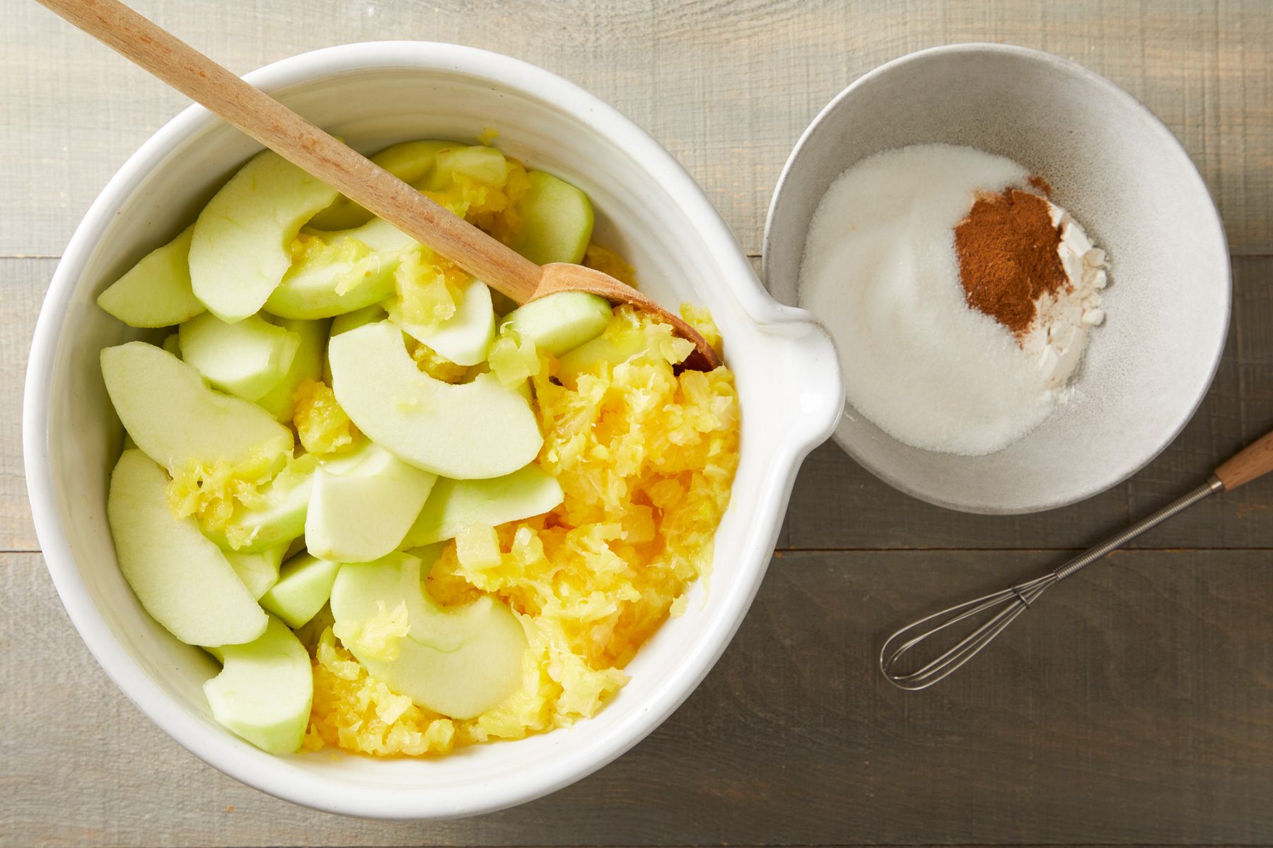 In a large bowl, combine the apples and pineapple.