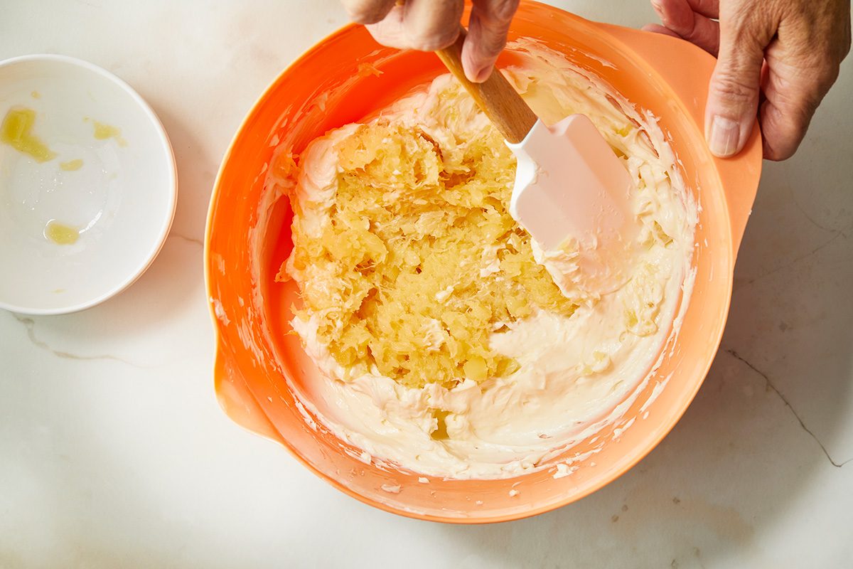 Overhead shot of a large bowl beat cream cheese and sugar until smooth