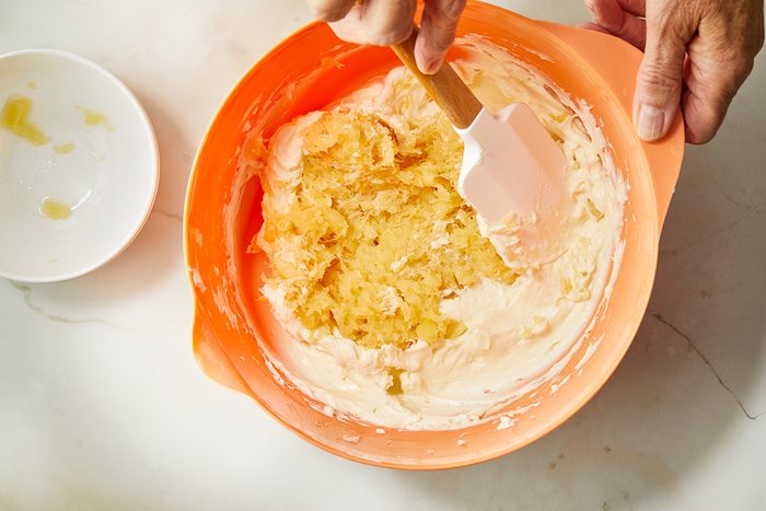 Overhead shot of a large bowl beat cream cheese and sugar until smooth